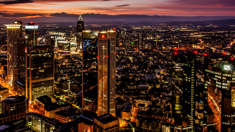 The beautiful city with high skyscrapers gleaming under the colourful sky at night