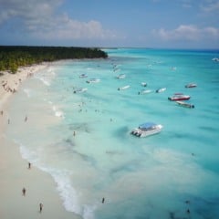 Look from above at turquoise water along golden beach somewhere in Dominican Republic