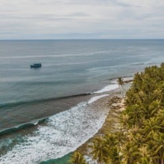 The mesmerizing view of the coastline with white sand and turquoise clear water in Indonesia