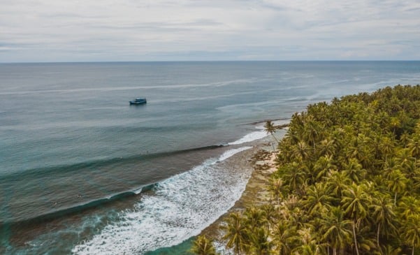 The mesmerizing view of the coastline with white sand and turquoise clear water in Indonesia